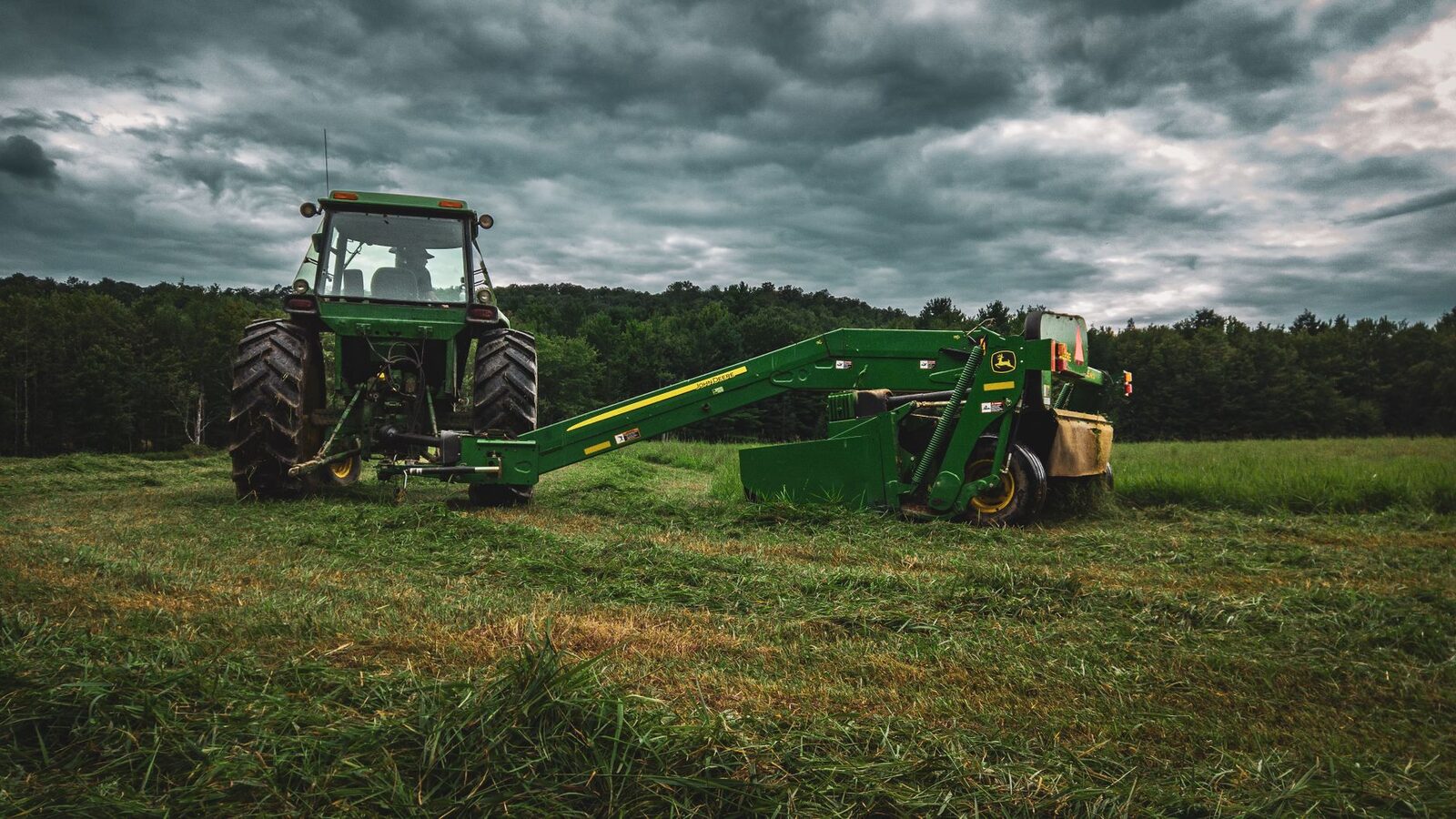 Green and yellow John Deere tractor in a field